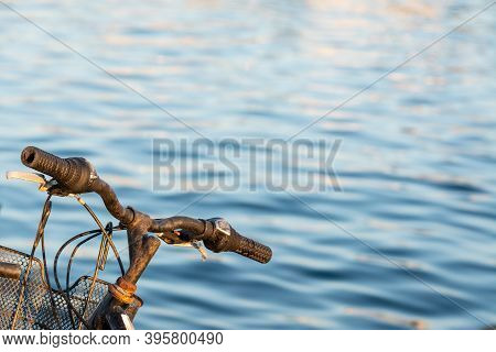 Rusty Bike Handlebar By The Sea At Sunset