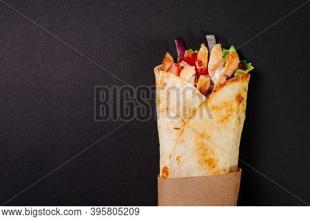 Chicken Shawarma On A Dark Background. Shawarma With Chicken In Pita Bread