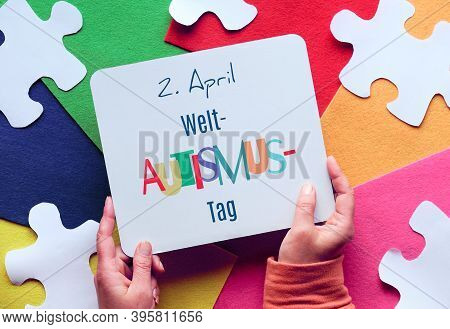 Hands Hold Board. Text In German Means April 2 Autism World Awareness Day. Puzzle, Layered Felt.