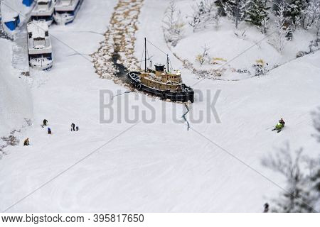Miniature Icebreaker On The River With Fishermen.