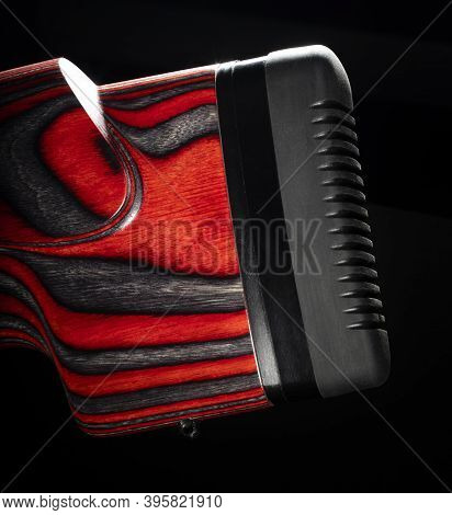 Recoil Pad On A Rifle With A Red And Black Laminated Stock On Black