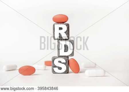 A Group Of White And Red Pills And Cubes With The Word Rds Respiratory Distress Syndrome On Them, Wh