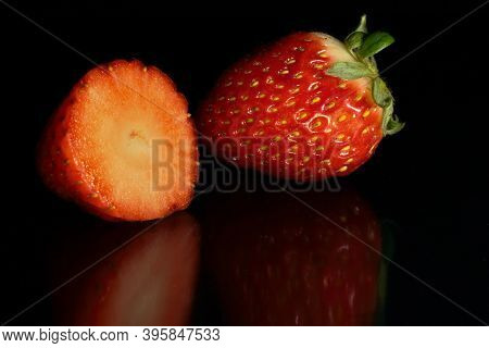 Whole And Split Strawberry On Black Background And Base With Reflections
Enviar Comentarios
Historia