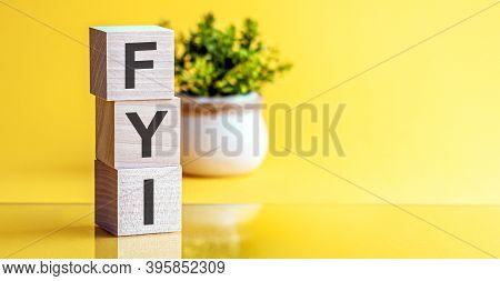 Fyi - Acronym From Wooden Blocks With Letters, Fyi - For Your Information. Yellow Background.