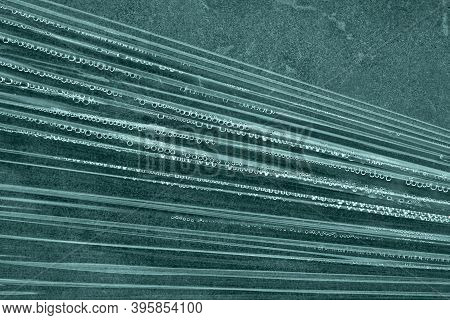 Abstract Background Color 2021 Tidewater Green. Film And Water Drops On Concrete