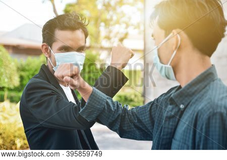 Asian Men Raised Their Hands To Greet Each Other. Avoid Spreading The Coronavirus Outside The Home T