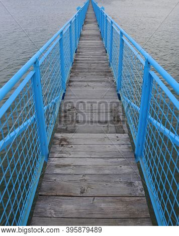Long Blue Bridge That Leads To Infinity In The Middle Of The Sea