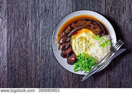 German Food: Blutwurst Or Blood Sausage Served On A Plate With Sauerkraut, Mashed Potato Parsley, Mu