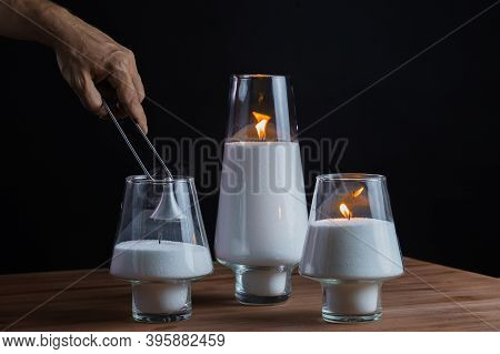 Hand Extinguishes The Candles. Candles Smoke. Black Background