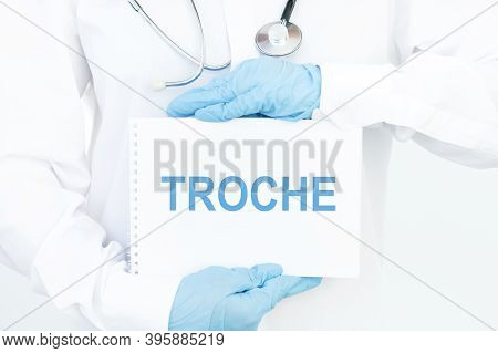 Doctor Holds A Card With The Name Of The Diagnosis Troche. Medical Concept.