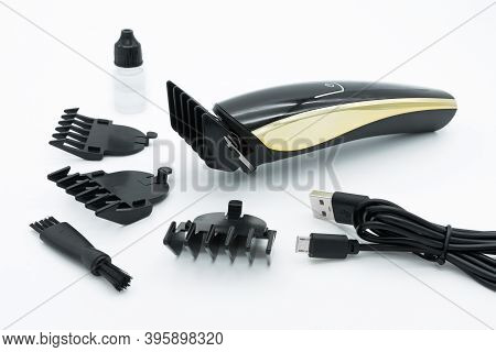 A Set Of The Cordless Electric Hair Clipper Isolated On The White Background.
