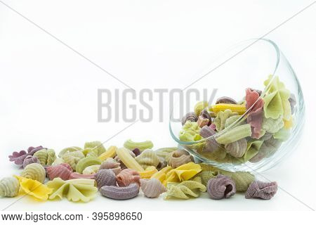 Close-up View Of The Colorful Macaroni  In Glass Bowl Isolated On The White Background.