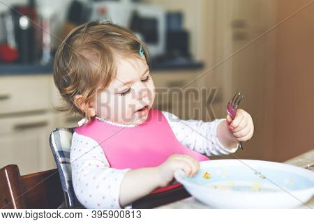 Adorable Baby Girl Eating From Spoon Mashed Vegetables And Puree. Food, Child, Feeding And People Co