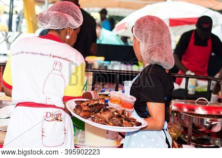 -	Abidjan, Ivory Coast, September 11 2016: Barbecue Party In Abidjan. Young Woman Hand Tray Filled W