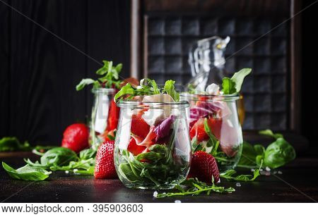 Fresh Salad With Spicy Arugula, Goat Cheese, Strawberry And Prosciutto Or Ham In Modern Glass Jars O