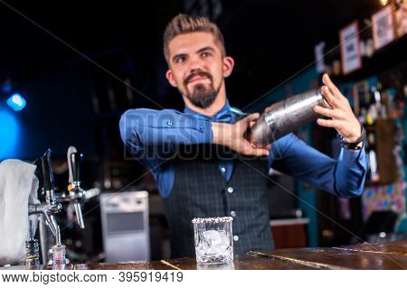 Young Barman Mixes A Cocktail On The Bar