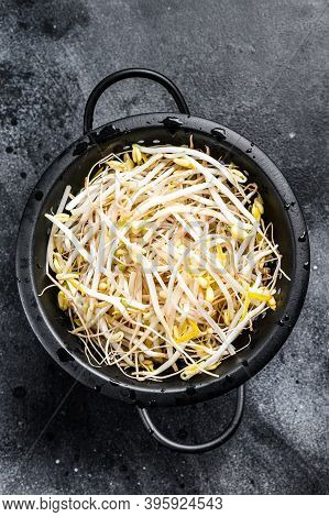 Sprouts Of Sprouted Beans In A Colander. Vegetarian Food. Black Background. Top View