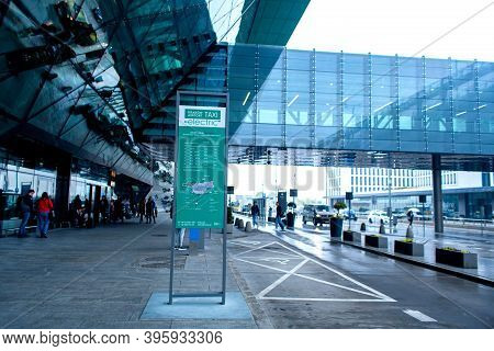 Banner Advertising A Taxi At The Airport Terminal. Krakow, Poland - 05.15.2019