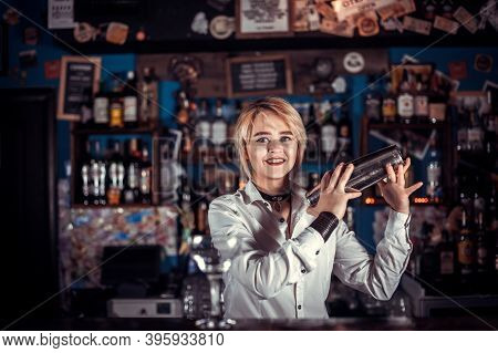 Experienced Girl Barman Demonstrates The Process Of Making A Cocktail