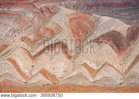 Interesting background of red banded strata viewed from Highway 163. The zigzag pattern is result of erosion of the tilted strata. Mexican Hat, Utah - USA