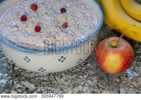 Fresh Yogurt With Cereals And Sliced Fruits, Banana, Apple, Decorated With Little Strawberry From Th