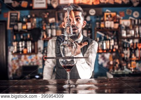 Charismatic Mixologist Makes A Cocktail While Standing Near The Bar Counter In Nightclub
