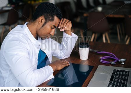 Serious African American Black Man Doctor In White Coat Uniform Working Typing On Laptop Computer, L