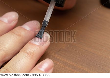 Applying Primer, Colorless Nail Polish With Brush On Finger