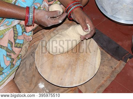 Women Prepair Breade In The Kitchen. Indian Woman Wearing Saree And Prepairing Food.