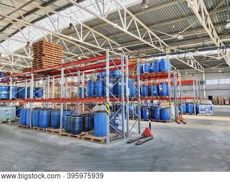 Small Warehouse With Shelves And Barrels. Place Of Storage Of Goods And Equipment