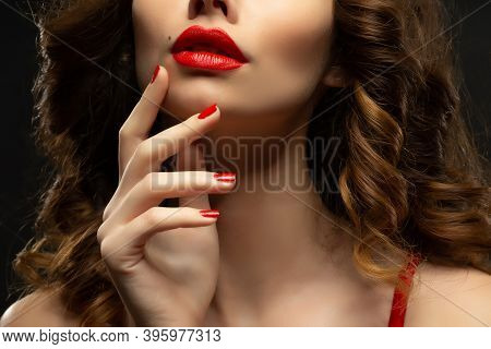 Beautiful Young Model With Red Lips And Red Manicure Hild White Sheet.