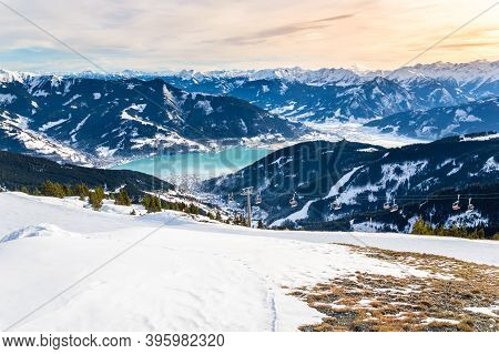 Zell Am See And Schmitten Town At Zeller Lake In Winter. View From Schmittenhohe Mountain, Snowy Ski