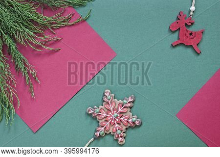 Christmas Background With Ornaments And Juniper Branches On Green And Red Textured Paper