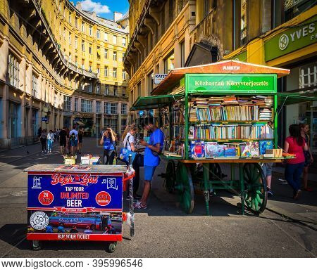 Budapest, Hungary, Aug 2019, People By A Book Cart In Anker Köz