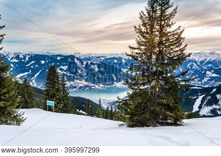 Zell Am See And Schmitten Town At Zeller Lake In Winter. View From Schmittenhohe Mountain, Snowy Ski