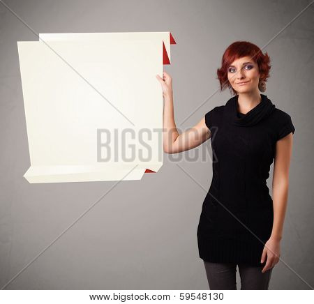 Baeutiful young woman holding white origami paper copy space