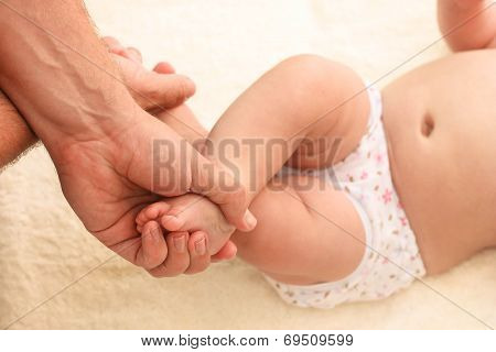 Masseur doing exercise for foot little baby