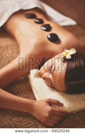 Portrait of young female lying in spa salon during beauty procedure
