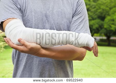 Closeup Of Bandaged Arm  With Park Background