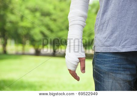 Closeup Of Bandaged Arm  With Park Background
