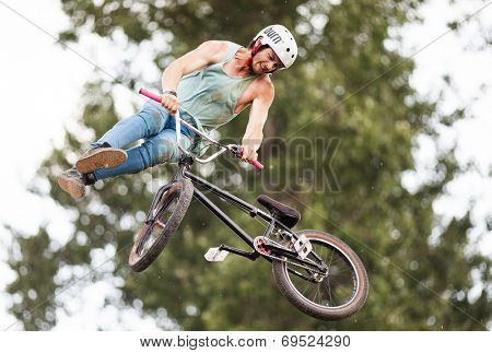 BONTIDA - JUNE 21: Unidentified BMX rider making a bike jump during the BMX Competition, at Electric Castle Festival on June 21, 2014 in the Banffy castle in Bontida, Romania