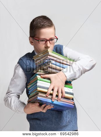 Schoolboy in glasses with books