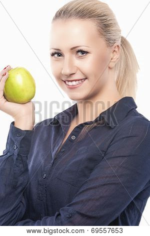 Dental Health Concept: Causasian Blond Female With Green Apple In Front Of Her Mouth