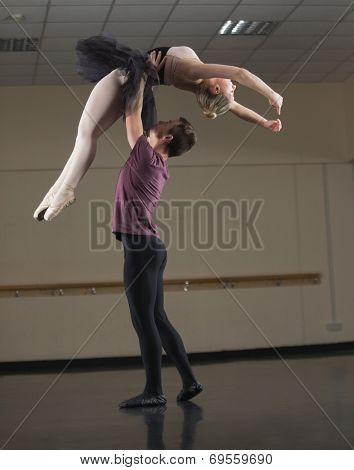 Ballet partners dancing gracefully together in the ballet studio