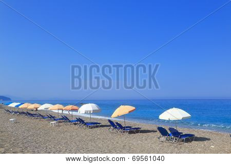Sandy beach with parasols and sunbeds, Gialos Lefkada Greece 