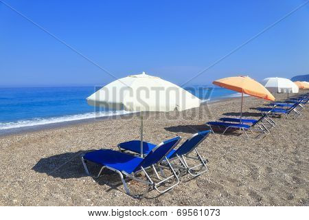 Sandy beach with parasols and sunbeds, Gialos Lefkada Greece 