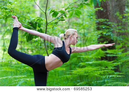 Lady practicing yoga in the nature.