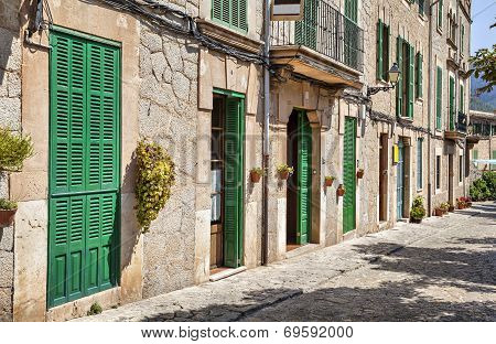 Building With Green Doors And Shutters