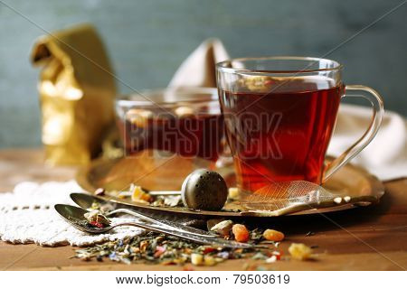 Beautiful vintage composition with herbal tea, on wooden table
