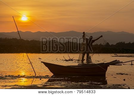 silhouette man fishing and sunset in Thailand